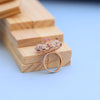 "Elegant Rose Gold Floral Ring with Pink Gemstone & White Accents"